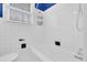 Simple bathroom with white fixtures and tiled walls, including a shower-tub combo at 2107 Old Dallas Sw Rd, Marietta, GA 30064