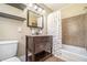 Bathroom with a dark vanity, brown tile shower, and decorative shower curtain at 2107 Old Dallas Sw Rd, Marietta, GA 30064