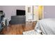 Bedroom featuring hardwood floors, gray dresser with TV, and white doors at 2107 Old Dallas Sw Rd, Marietta, GA 30064
