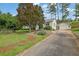 View of a one story home with a long driveway leading to a detached two car garage at 2107 Old Dallas Sw Rd, Marietta, GA 30064