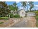 View of a one story home with a long driveway leading to a detached two car garage at 2107 Old Dallas Sw Rd, Marietta, GA 30064