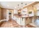 Bright kitchen with wood island, white cabinetry, and hardwood floors leading to a living area at 2107 Old Dallas Sw Rd, Marietta, GA 30064