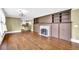 Open living room with hardwood floors, a decorative fireplace, and built-in shelves and cabinets at 2107 Old Dallas Sw Rd, Marietta, GA 30064