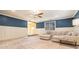 Cozy living room with blue accent wall, plush carpet and sectional sofa at 2107 Old Dallas Sw Rd, Marietta, GA 30064