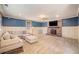 Spacious living room featuring a brick fireplace, wainscoting, and a comfortable sectional sofa at 2107 Old Dallas Sw Rd, Marietta, GA 30064