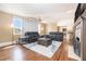 Open-concept living room with hardwood floors, a decorative fireplace, and comfortable seating at 2107 Old Dallas Sw Rd, Marietta, GA 30064