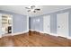 Inviting main bedroom with hardwood floors, blue walls, bright lighting, and an en-suite bathroom at 2107 Old Dallas Sw Rd, Marietta, GA 30064