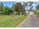 View of a one story home with a long driveway leading to a detached two car garage at 2107 Old Dallas Sw Rd, Marietta, GA 30064