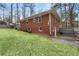 Brick home exterior, showcasing the fenced backyard with manicured lawn at 3245 Westmart Ln, Atlanta, GA 30340