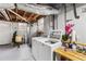 Unfinished basement features a laundry area, exposed ductwork, and painted concrete flooring at 3245 Westmart Ln, Atlanta, GA 30340