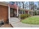 Charming brick home featuring a welcoming front porch and American flag at 3245 Westmart Ln, Atlanta, GA 30340