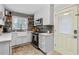 Well-lit kitchen featuring white cabinets, stylish backsplash, and modern appliances at 3245 Westmart Ln, Atlanta, GA 30340