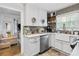 Bright kitchen features white cabinets, stainless steel appliances, and a farmhouse sink at 3245 Westmart Ln, Atlanta, GA 30340