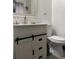 Modern bathroom features a white vanity with drawers, a toilet, and stylish fixtures at 1074 Hobson Sw St, Atlanta, GA 30310