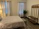 Comfortable bedroom has a soft rug, modern furnishings and a decorative plant at 1074 Hobson Sw St, Atlanta, GA 30310