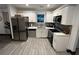 Bright kitchen featuring stainless steel appliances, white cabinets, and light gray backsplash at 1074 Hobson Sw St, Atlanta, GA 30310