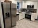 Bright kitchen featuring stainless steel appliances, white cabinets, and light gray backsplash at 1074 Hobson Sw St, Atlanta, GA 30310