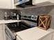 Close up of the stainless steel stove, microwave hood and decor on the white quartz counter at 1074 Hobson Sw St, Atlanta, GA 30310