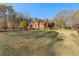 Wide shot of a large yard and the back of a brick home with a wooden fence surrounding the perimeter at 238 Chappell Rd, Fayetteville, GA 30215