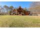 Expansive backyard featuring a covered porch, spacious lawn, and classic brick home at 238 Chappell Rd, Fayetteville, GA 30215