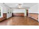 Large basement with hardwood floors, white walls, brick accents and glass doors leading to the backyard at 238 Chappell Rd, Fayetteville, GA 30215