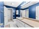 Blue bathroom with a long vanity, white countertop, and a large mirror at 238 Chappell Rd, Fayetteville, GA 30215