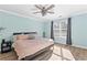 Serene bedroom featuring soft blue walls, a ceiling fan, and natural light at 238 Chappell Rd, Fayetteville, GA 30215