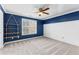 Charming bedroom featuring a ceiling fan, window, and rustic wooden shelving at 238 Chappell Rd, Fayetteville, GA 30215