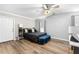 Cozy bedroom featuring wood-look floors, ceiling fan, and neutral decor at 238 Chappell Rd, Fayetteville, GA 30215