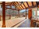 A covered porch featuring a wooden deck with ceiling fans and an outdoor kitchen at 238 Chappell Rd, Fayetteville, GA 30215