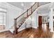 Elegant foyer showcasing a staircase with wooden railing, hardwood floors, and wainscoting at 238 Chappell Rd, Fayetteville, GA 30215