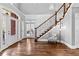 Stunning foyer with hardwood floors, elegant staircase, and natural light streaming through the entryway at 238 Chappell Rd, Fayetteville, GA 30215