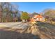 Front exterior of brick home with a circular driveway and a spacious lawn at 238 Chappell Rd, Fayetteville, GA 30215