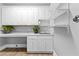 Spacious laundry room with white cabinets, granite countertops, sink, and shelving at 238 Chappell Rd, Fayetteville, GA 30215