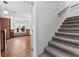 Spacious living room with hardwood floors, exposed brick accent wall, and staircase at 238 Chappell Rd, Fayetteville, GA 30215