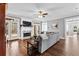 Cozy living room with a fireplace, ceiling fan, gray couch, and hardwood flooring at 238 Chappell Rd, Fayetteville, GA 30215