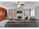 Cozy living room with a fireplace, ceiling fan, gray couch, and hardwood flooring at 238 Chappell Rd, Fayetteville, GA 30215