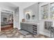 Well-lit vanity with a granite counter and a window view of a wooded yard at 238 Chappell Rd, Fayetteville, GA 30215