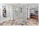 Modern glass enclosed shower with tile surround next to the bedroom and walk-in closet at 238 Chappell Rd, Fayetteville, GA 30215