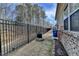 Backyard with a wrought iron fence and tree line offering privacy and security at 3030 Appling Hills Dr, Dacula, GA 30019