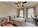 Inviting bedroom with soft carpet, two windows, a ceiling fan and a computer desk at 3030 Appling Hills Dr, Dacula, GA 30019