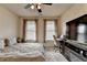 This inviting bedroom features soft carpet, two windows, a ceiling fan and a TV at 3030 Appling Hills Dr, Dacula, GA 30019