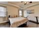 Bright bedroom featuring tray ceilings and hardwood floors, with a treadmill for exercise at 3030 Appling Hills Dr, Dacula, GA 30019