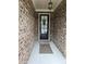 The front door is framed by a stylish brick facade at 3030 Appling Hills Dr, Dacula, GA 30019