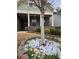 Landscaped front yard featuring daffodils and rocks at charming brick home at 3030 Appling Hills Dr, Dacula, GA 30019