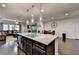 The kitchen and dining area offers an open layout, stylish lighting, and stainless appliances at 3030 Appling Hills Dr, Dacula, GA 30019