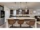 The kitchen features a large island, granite countertops, and modern pendant lighting at 3030 Appling Hills Dr, Dacula, GA 30019