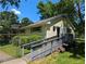 Exterior view of building featuring yard, ramp, and mature tree landscaping at 3941 Covered Bridge Sw Rd, Smyrna, GA 30082