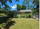 Exterior view of building with covered front porch, a yard, and mature tree landscaping at 3941 Covered Bridge Sw Rd, Smyrna, GA 30082