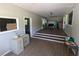 Open living room space featuring hardwood flooring, white file cabinets, and stairs to main room at 3941 Covered Bridge Sw Rd, Smyrna, GA 30082